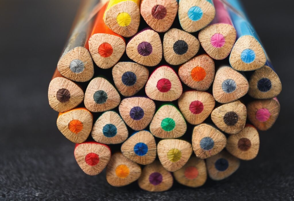 Stack of colorful pencils tips, art background