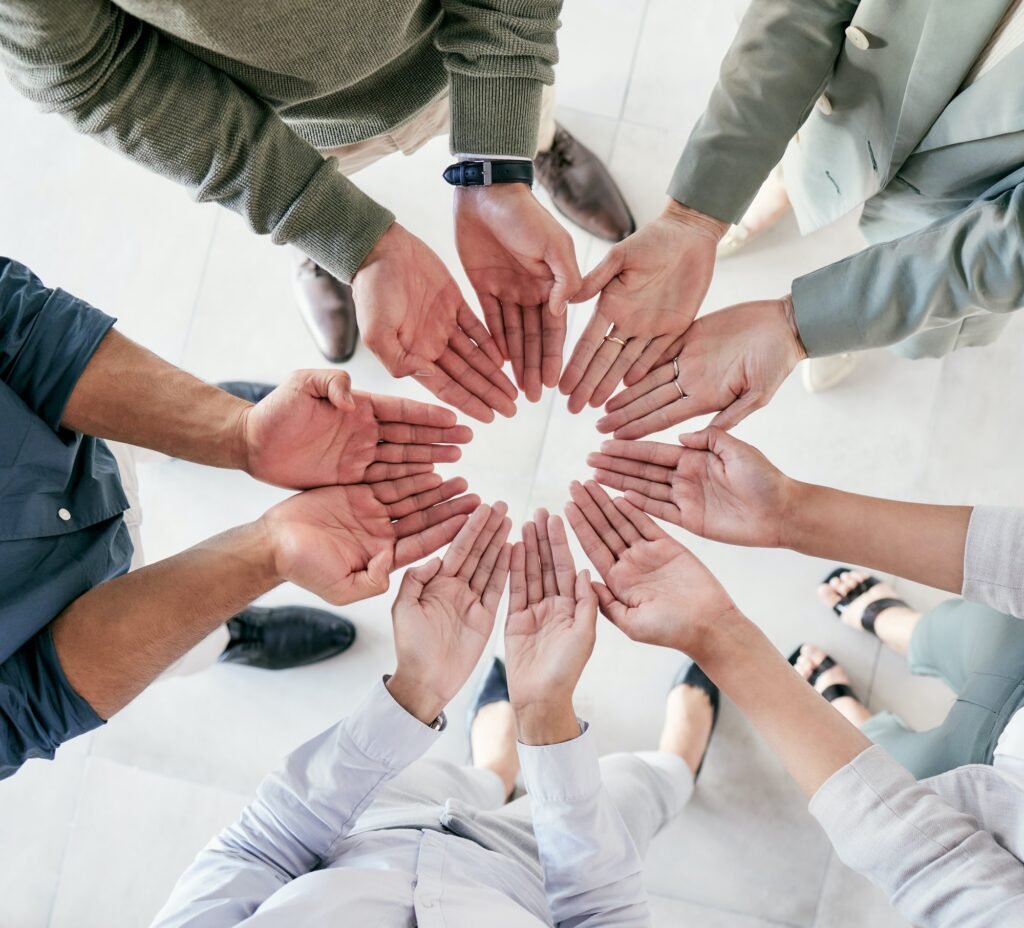 Were the team youre looking for. Shot of a group of businesspeople joining hands in solidarity.